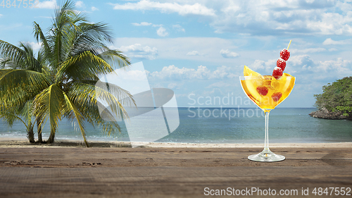 Image of Summer refreshing cocktail with sea or ocean beach on background