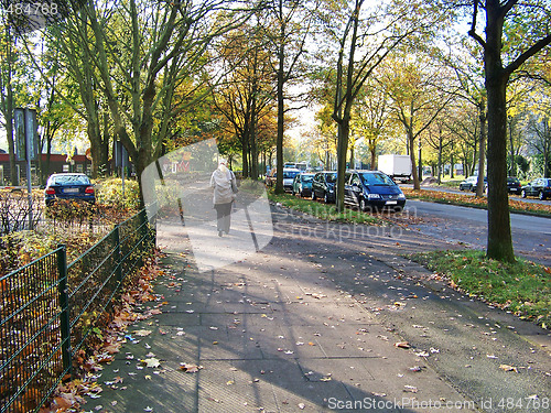 Image of The lonely woman on a path in the autumn.