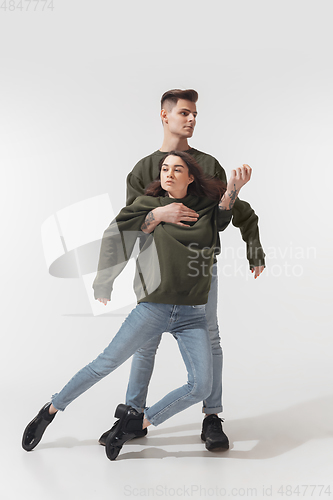 Image of Trendy fashionable couple isolated on white studio background