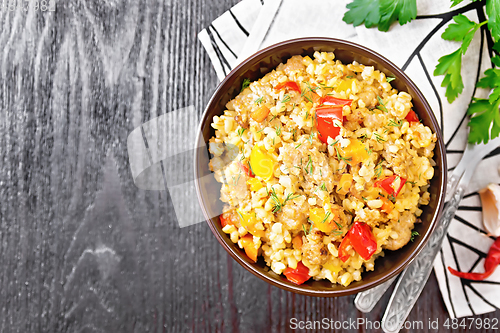 Image of Barley porridge with minced meat in bowl on black board top