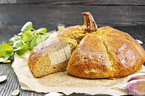 Image of Bread pumpkin cut on a dark board