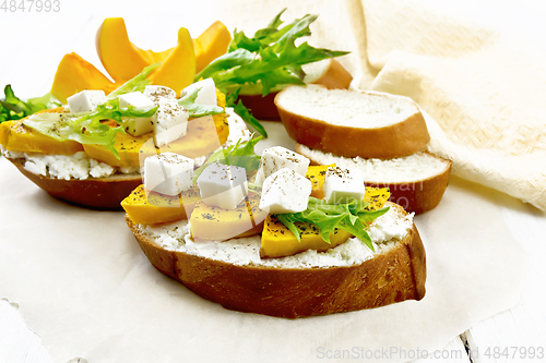 Image of Bruschetta with pumpkin and ricotta on white board