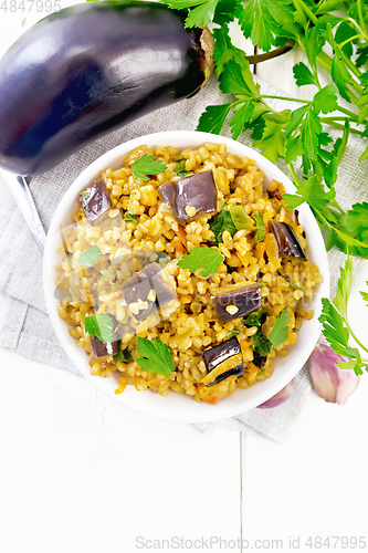 Image of Bulgur with eggplant in bowl on light board top