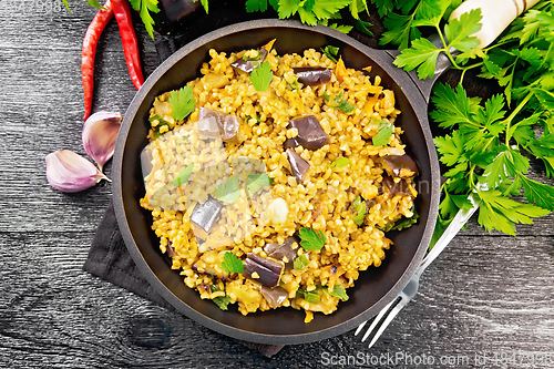 Image of Bulgur with eggplant in pan on board top