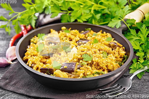 Image of Bulgur with eggplant in pan on board