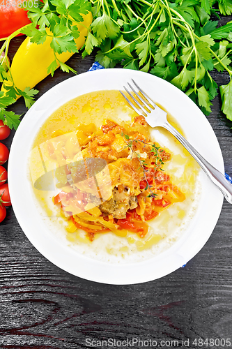 Image of Chicken with pepper in white plate on board top