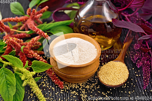 Image of Flour amaranth in bowl and oil on dark board