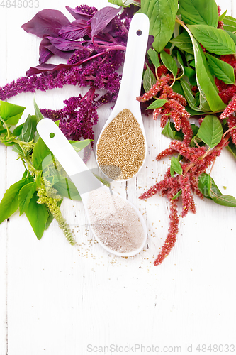 Image of Flour and seeds amaranth in spoons on board top