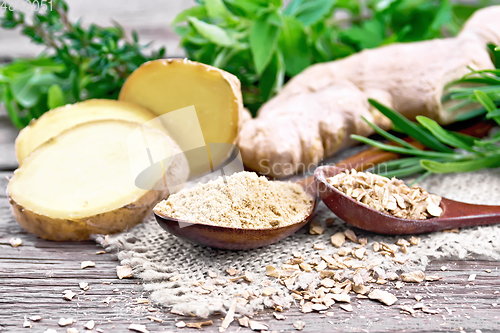 Image of Ginger ground and flakes in spoons with root on board