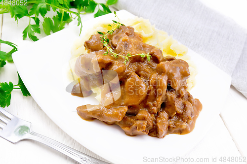 Image of Goulash of beef with mashed potatoes in plate on board