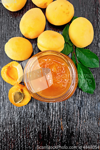 Image of Jam apricot in jar on dark board top