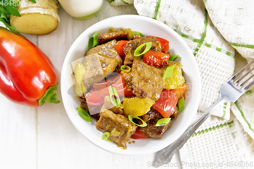 Image of Meat with oranges in bowl on board top