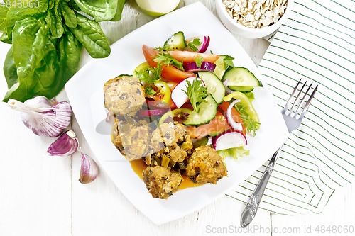 Image of Meatballs with spinach and oatmeal on board top