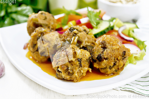 Image of Meatballs with spinach and oatmeal on board