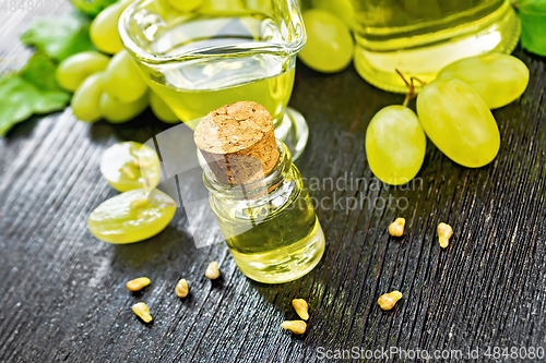 Image of Oil grape in vial on dark board