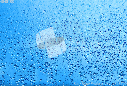 Image of Water drops on glass, natural blue texture
