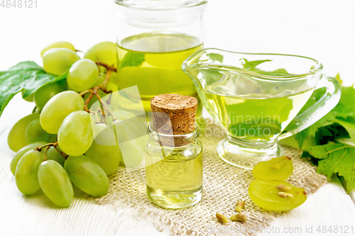 Image of Oil grape in vial on white board