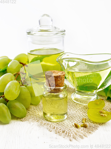 Image of Oil grape in vial on wooden board