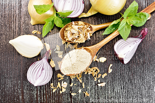 Image of Onion powder and flakes in spoons on wooden board top