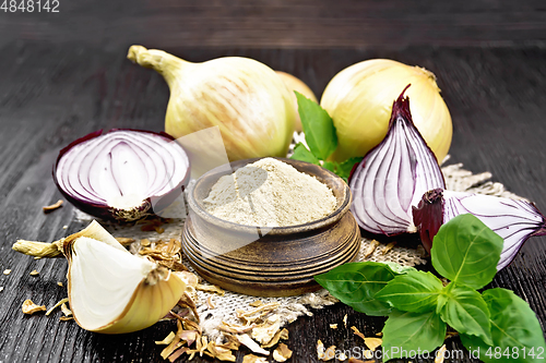 Image of Onion powder in bowl on dark board