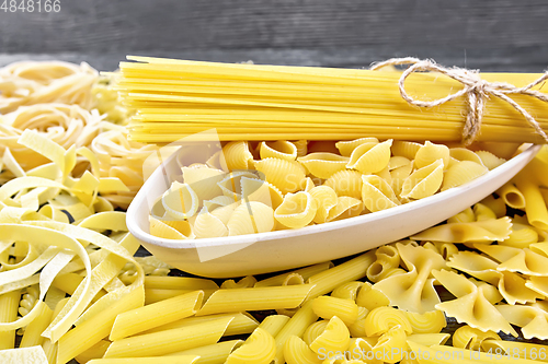 Image of Pasta different with bowl on wooden board