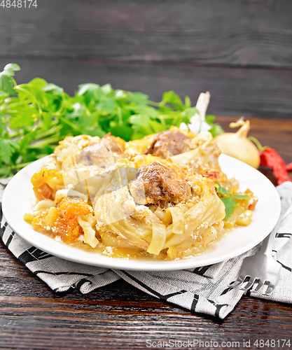 Image of Pasta with meatballs in plate on napkin