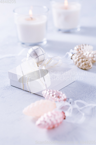 Image of Christmas ornaments and small present in white