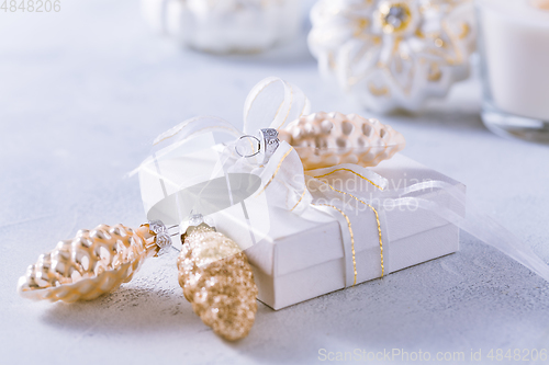 Image of Christmas ornaments and small present in white