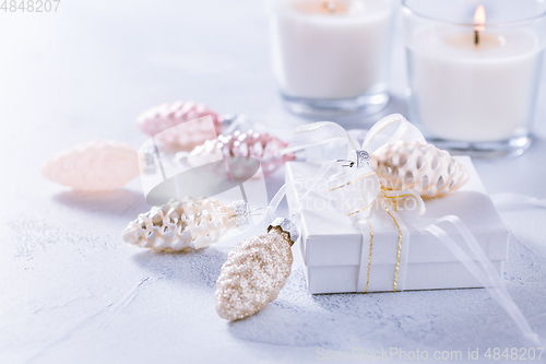 Image of Christmas ornaments and small present in white