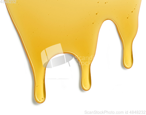 Image of flowing honey on white background