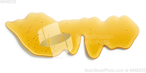 Image of flowing honey on white background