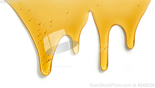 Image of flowing honey on white background