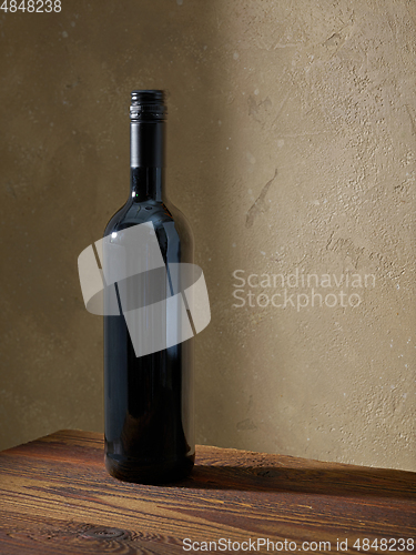 Image of whine bottle on wooden table