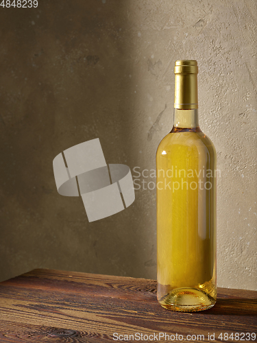 Image of whine bottle on wooden table