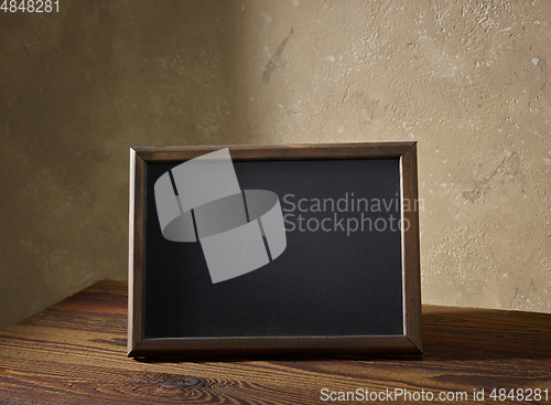 Image of blackboard in a wooden frame on a table