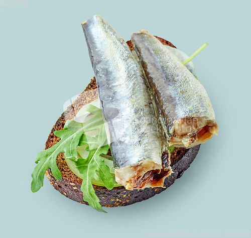 Image of canned sardines on bread slice