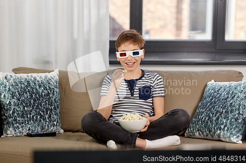 Image of boy in 3d movie glasses and watching tv at home