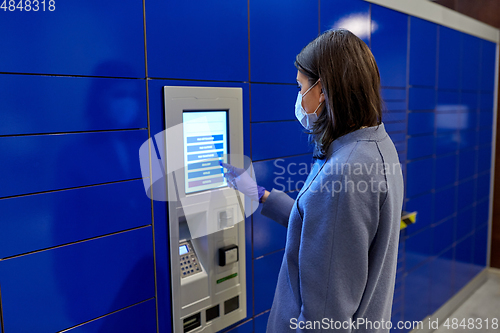 Image of woman in mask at parcel machine