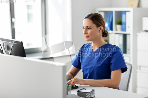 Image of doctor or nurse with computer working at hospital