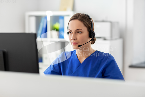 Image of doctor with headset and computer at hospital