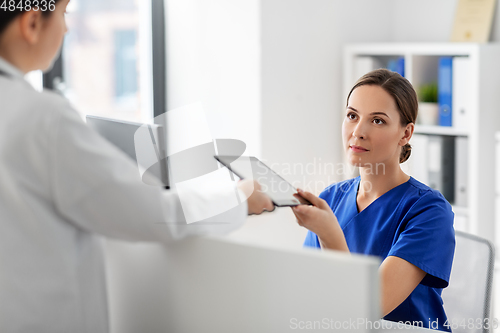 Image of doctor and nurse with tablet computer at hospital