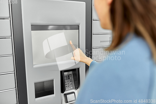 Image of woman using automated parcel machine