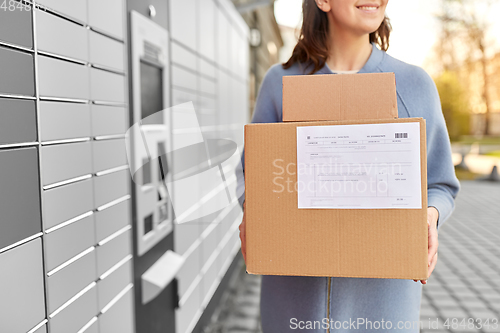 Image of woman with boxes at automated parcel machine