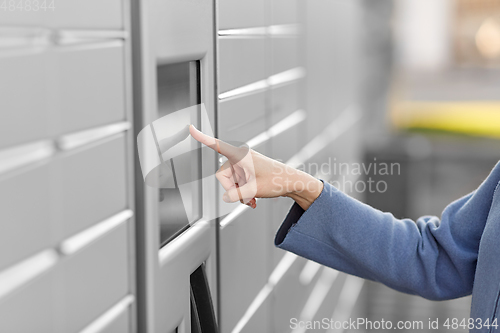Image of close up of hand using automated parcel machine