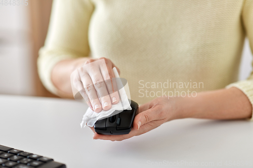 Image of close up of woman cleaning computer mouse