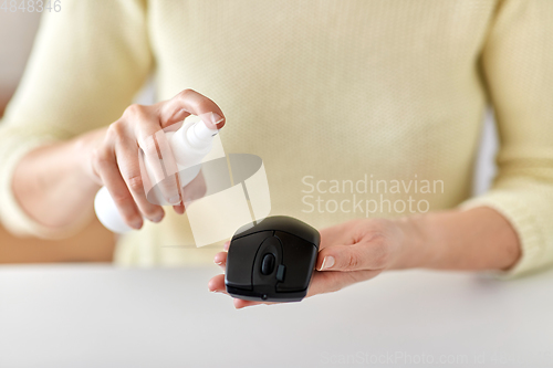 Image of close up of woman cleaning computer mouse