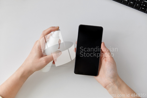 Image of close up of woman cleaning smartphone