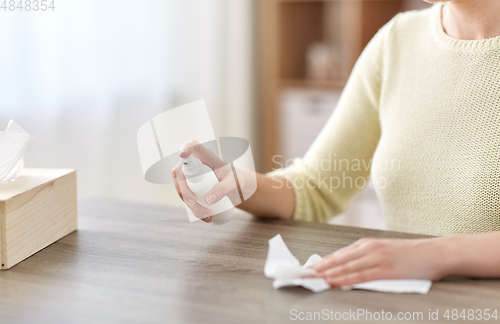 Image of close up of woman cleaning table at home