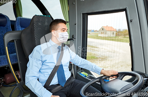 Image of bus driver in mask talking to microphone