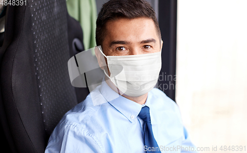 Image of close up of bus driver in medical mask